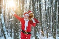 New year concept. Grandfather Santa walks in forest. Real Santa Claus in red cap pulling large red gift sack. Santa