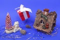 New year concept. Hut, snowman, Christmas tree and a gift on a blue background Royalty Free Stock Photo