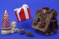 New year concept. Hut, snowman, Christmas tree and a gift on a blue background Royalty Free Stock Photo