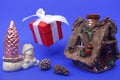 New year concept. Hut, snowman, Christmas tree and a gift on a blue background Royalty Free Stock Photo