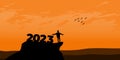 New Year 2023 concept. Man meets dawn in mountains for new year 2023. New Start motivation inspirational quote message on silhouet