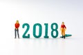 2018 New year concept man and woman miniature figures standing o Royalty Free Stock Photo