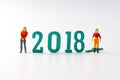 2018 New year concept man and woman miniature figures standing o Royalty Free Stock Photo