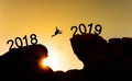 New year concept, silhouette a man jumping across cliff from 2018 to 2019 Royalty Free Stock Photo