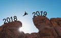 New year concept, silhouette a man jumping across cliff from 2018 to 2019 Royalty Free Stock Photo