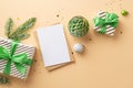 New Year concept. Top view photo of envelope paper sheet white and green baubles gift boxes pine branch in hoarfrost and confetti Royalty Free Stock Photo