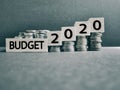 new year concept of words budget 2020 on wooden blocks with stack of coins background Royalty Free Stock Photo