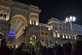 New Year concert at the Duomo square with a lot of people present and the famous Vittorio Emanuele II Gallery in background.