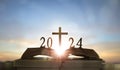 2024 new year and cross of jesus christ on open holy bible with sunrise background Royalty Free Stock Photo