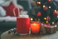 New Year cup with marshmallows, candle and gift on the table on a festive background. Christmas mood Royalty Free Stock Photo