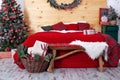 New Year decorated bedroom. Spacious rustic white bedroom with decorated Christmas tree and Christmas wreath on wall. Xmas in morn