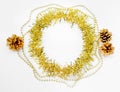 New year decorations of round circle yellow tinsel, golden bumps, chain of balls, beads on a white background. Christmas Royalty Free Stock Photo