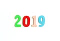 New Year decorative composition with 2019 colorful wooden small numbers. Festive card with empty space for message Royalty Free Stock Photo