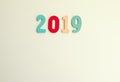 New Year decorative composition with 2019 colorful wooden small numbers. Festive card with empty space for message Royalty Free Stock Photo