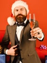 New year eve. Santa in retro suit shows alcoholic drink