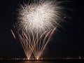 Colorful fireworks burst in the night sky with light trails Royalty Free Stock Photo