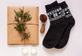 New year 2021 flat lay. Black ornamental socks, gift box in eco kraft paper with pine tree cones. Zero waste Christmas Royalty Free Stock Photo