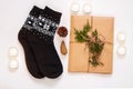 New year 2021 flat lay. Black ornamental socks, gift box in eco kraft paper with pine tree cones. Zero waste Christmas Royalty Free Stock Photo