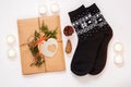 New year 2021 flat lay. Black ornamental socks, gift box in eco kraft paper with pine tree cones. Zero waste Christmas Royalty Free Stock Photo