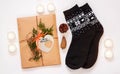 New year 2021 flat lay. Black ornamental socks, gift box in eco kraft paper with pine tree cones. Zero waste Christmas Royalty Free Stock Photo