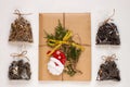 New year flat lay. Christmas tea gift box wrapped in kraft paper with pine tree cones.Mockup template. Winter holidays