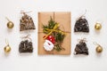 New year flat lay. Christmas tea gift box wrapped in kraft paper with pine tree cones.Mockup template. Winter holidays