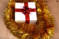 New Year gift on a golden tinsel background boly Royalty Free Stock Photo