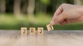 2023 new year goal planning idea, wood block cube on wooden table with new year 2023 and target icon, business vision