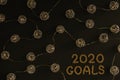 New Year goals 2020. Black background decorated with Christmas decorations, spherical metallic lights connected with each other Royalty Free Stock Photo