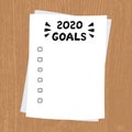 2020 New Year, Goals. Clipboard with white sheet. Text on paper on wooden background, written by hand. Lettering 2020 Royalty Free Stock Photo