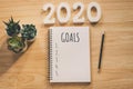 New year 2020 goals list. Office desk table with notebooks and pancil with pot plant Royalty Free Stock Photo