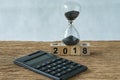 new year 2018 goals, target minimal concept as number 2018 wooden cube block with sandglass and calculator on wooden table Royalty Free Stock Photo