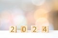 2024 new year greeting card template, 2024 on wooden cubes on white table and blur background, banner with copy space for text