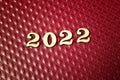 2022 new year greeting card template, 2022 on wooden number`s on red square leather background