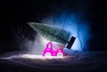 Miniature car with fir tree on Snowy Winter Fores, or toy car carrying a christmas tree and at night time Royalty Free Stock Photo