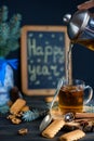 New Year holiday. Fragrant tea in a transparent glass cup. Christmas New Years and spruce on the table