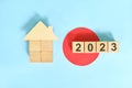 New year 2023 house or home ownership and real estate property concept. Wooden blocks on blue background Royalty Free Stock Photo