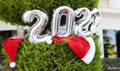 New Year 2022 inflatable figures on a green thuja in the garden Royalty Free Stock Photo