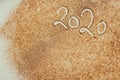 2020 New Year inscription. Golden glitter background texture. Christmas theme. New Year celebration. Confetti on the table.