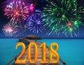 New Year inscription 2018 on the wooden road over the sea and New Year`s fireworks Royalty Free Stock Photo