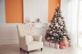 New Year interior with armchair and christmas tree. Pink and ora