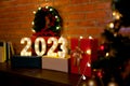 New year 2023 light symbols are set near gift box and Christmas tree for concept of happy new year for happiness family Royalty Free Stock Photo