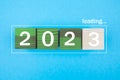 2023 New Year Loading. Loading bar with wooden blocks 2023 on blue background