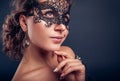 New year masquerade party. Beautiful young woman wearing lace carnival mask and jewellery. Fashion Royalty Free Stock Photo