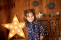 New Year 2020. Merry Christmas, happy holidays. Close-up portrait of a little girl Magic Light in Night Xmas Tree Interior