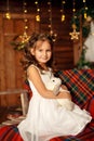 New Year 2020. Merry Christmas, happy holidays. Close-up portrait of a little girl Magic Light in Night Xmas Tree Interior