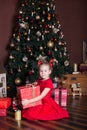 New Year 2020! Merry Christmas, happy holidays! Little girl holds a gift, smiles, rejoices and awaits Christmas, New Year and holi Royalty Free Stock Photo