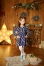 New Year 2020. Merry Christmas, happy holidays. A little girl Magic Light in Night Xmas Tree Interior