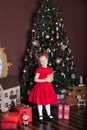 New Year 2020. Merry Christmas, happy holidays. Portrait of a little girl with a candle. Little girl holds a candle in front of a Royalty Free Stock Photo