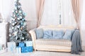 New Year 2020. Merry Christmas, happy holidays. Stylish living room interior with decorated Christmas tree, fireplace and comforta